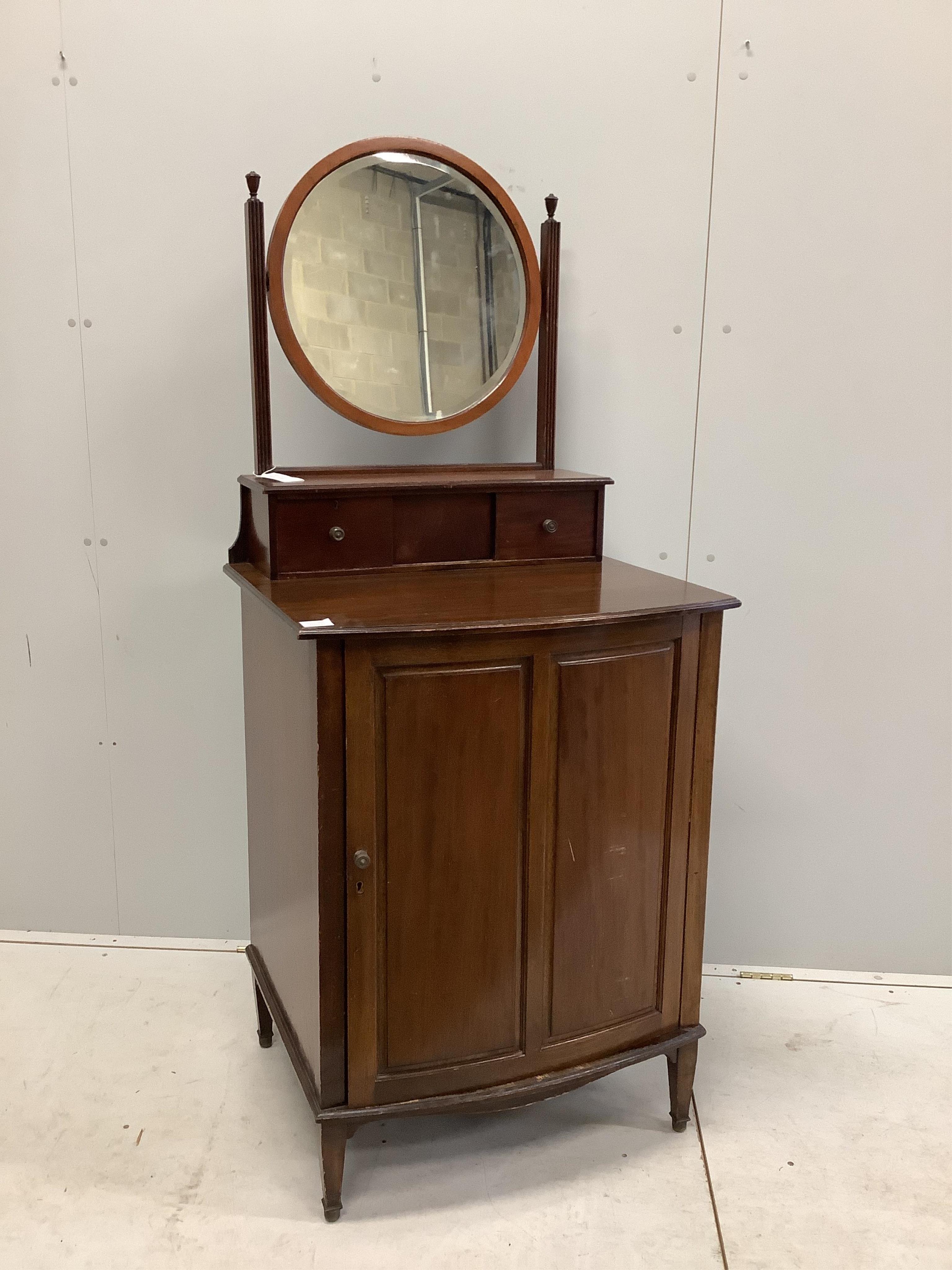 An early 20th century mahogany bowfront dressing chest, with bevelled plate circular mirror, and panelled cupboard base, width 68cm, depth 58cm, height 158cm. Condition - fair